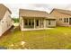 Rear view of home featuring lawn, covered patio, and neutral siding at 444 Silverbell Ct, Peachtree City, GA 30269