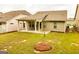 Backyard featuring newly planted tree, lawn, and covered patio at 444 Silverbell Ct, Peachtree City, GA 30269