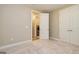 Empty bedroom features a double door closet and an entrance to the laundry room at 444 Silverbell Ct, Peachtree City, GA 30269