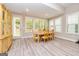 Bright dining area with wood floors, and door to the outdoor space at 444 Silverbell Ct, Peachtree City, GA 30269