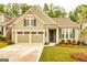 Charming home featuring a two-car garage, manicured lawn, and a welcoming front porch at 444 Silverbell Ct, Peachtree City, GA 30269