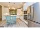 Well-lit kitchen with stainless steel appliances, white cabinetry, and a view into an adjoining living space at 444 Silverbell Ct, Peachtree City, GA 30269