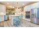 Bright kitchen with white cabinetry, stainless steel appliances, and a cozy breakfast bar with seating at 444 Silverbell Ct, Peachtree City, GA 30269