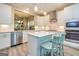 Bright kitchen with white cabinetry, stainless steel appliances, and a cozy breakfast bar with seating at 444 Silverbell Ct, Peachtree City, GA 30269