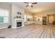 Bright living room with wood flooring, a fireplace, and plantation shutters at 444 Silverbell Ct, Peachtree City, GA 30269