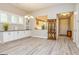 Open concept living room with built-in cabinets, wood floors and a view into the kitchen at 444 Silverbell Ct, Peachtree City, GA 30269