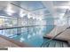 Large indoor pool with abundant light from large windows, offering a serene swimming experience at 444 Silverbell Ct, Peachtree City, GA 30269