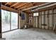 Unfinished basement featuring open ceilings, concrete flooring, and a sliding glass door at 101 Longer Dr, Peachtree City, GA 30269