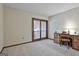 Bedroom with a desk, chair, and sliding glass doors leading to a private balcony at 101 Longer Dr, Peachtree City, GA 30269