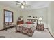 Cozy bedroom featuring a ceiling fan, patterned bedding, and complementing side tables at 101 Longer Dr, Peachtree City, GA 30269