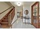 Hallway with wooden stairs, marble floors and views into the kitchen and living areas at 101 Longer Dr, Peachtree City, GA 30269