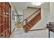 Warm foyer with classic staircase and views into the living areas at 101 Longer Dr, Peachtree City, GA 30269