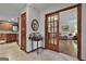 Inviting hallway leading to the living room with rich wood trim and marble floors at 101 Longer Dr, Peachtree City, GA 30269