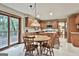 Bright eat-in kitchen with granite counters, wood cabinets, and a dining table near a sliding glass door at 101 Longer Dr, Peachtree City, GA 30269