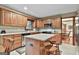Kitchen featuring granite countertops, wooden cabinetry, stainless appliances, and an island with bar stools at 101 Longer Dr, Peachtree City, GA 30269