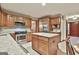 Well-equipped kitchen with granite countertops, a stainless steel stove, and a large central island at 101 Longer Dr, Peachtree City, GA 30269