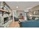 Spacious living room with stone fireplace, hardwood floors, and comfortable leather seating at 101 Longer Dr, Peachtree City, GA 30269