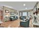 Bright living room with hardwood floors, stone fireplace, and comfortable leather sofas at 101 Longer Dr, Peachtree City, GA 30269