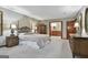 Cozy main bedroom with carpet, wood furniture, ensuite bathroom access, and warm lighting at 101 Longer Dr, Peachtree City, GA 30269