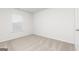 Bright bedroom featuring neutral carpet, white walls, and a window with blinds at 235 Oliver Dr, Locust Grove, GA 30248