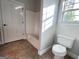 Bathroom offers a shower-tub combo and tile floors with natural light coming in through the window at 6504 Cedar Mountain Rd, Douglasville, GA 30134