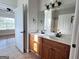 Bathroom features a double vanity and a door leading into a separate shower and bathtub at 6504 Cedar Mountain Rd, Douglasville, GA 30134