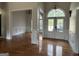 Open foyer with hardwood floors leading to the dining area, showcasing the home's bright and airy layout at 6504 Cedar Mountain Rd, Douglasville, GA 30134