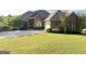 Beautiful single-story brick home featuring a lush green lawn, mature trees, and an inviting entrance at 6504 Cedar Mountain Rd, Douglasville, GA 30134