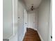 Hallway with hardwood floors, white trim, neutral walls, and classic light fixture at 6504 Cedar Mountain Rd, Douglasville, GA 30134