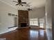 Bright living room features a stone fireplace, built-in shelving, hardwood floors and abundant natural light at 6504 Cedar Mountain Rd, Douglasville, GA 30134