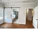 The main bedroom has hardwood floors and barn door leading into the main bathroom with bathtub and shower at 6504 Cedar Mountain Rd, Douglasville, GA 30134
