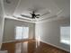 Spacious main bedroom features tray ceiling, ceiling fan, and access to the backyard through french doors at 6504 Cedar Mountain Rd, Douglasville, GA 30134