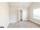 Neutral bedroom with carpet, closet, base trim, window, and ample natural light at 121 Crestwood Ct, Hampton, GA 30228