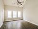 A light-filled bedroom with high ceilings, ceiling fan and wood flooring at 121 Crestwood Ct, Hampton, GA 30228