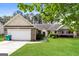 Charming single-story home with brick facade, attached garage, and well-maintained lawn at 121 Crestwood Ct, Hampton, GA 30228