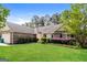 A cozy single-story home boasting lush green lawn and mature trees at 121 Crestwood Ct, Hampton, GA 30228