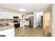Bright kitchen featuring stainless steel appliances, white cabinets, and granite countertops at 121 Crestwood Ct, Hampton, GA 30228