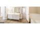 Bright main bathroom featuring a soaking tub, private shower, and dual sink vanity with a white countertop at 121 Crestwood Ct, Hampton, GA 30228
