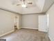 Neutral bedroom with a tray ceiling, fan, access to the main bathroom, and ample natural light at 121 Crestwood Ct, Hampton, GA 30228