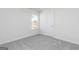 Bedroom with plush carpeting, neutral paint, window, and door at 455 Prescott Way, Villa Rica, GA 30180