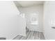 Bright entryway with gray wood-look floors, stairs to the second floor, and a door at 455 Prescott Way, Villa Rica, GA 30180