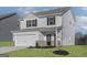 Inviting two-story home with a brick-accented facade and attached two-car garage at 455 Prescott Way, Villa Rica, GA 30180
