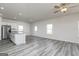 Open-concept living room with a kitchen island, stainless steel appliances, and plenty of windows at 455 Prescott Way, Villa Rica, GA 30180