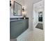 Modern bathroom with gray vanity, patterned floor tiles, and a view into the next bathroom at 300 Mado Ln # 329, Chattahoochee Hills, GA 30268