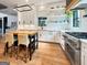 Open-concept kitchen with white cabinets, quartz countertops, a center island and stainless steel appliances at 300 Mado Ln # 329, Chattahoochee Hills, GA 30268