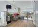 Upstairs living area features a gray sofa, hardwood floors, and modern railing at 300 Mado Ln # 329, Chattahoochee Hills, GA 30268