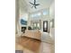 Cozy living room featuring a stone fireplace, hardwood floors, and access to an outdoor living space at 300 Mado Ln # 329, Chattahoochee Hills, GA 30268