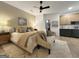 Spacious primary bedroom with a sitting area, ceiling fan, and connecting ensuite bathroom at 300 Mado Ln # 329, Chattahoochee Hills, GA 30268