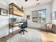 Well-lit office space with custom shelving, a neutral rug, and a cozy seating area at 300 Mado Ln # 329, Chattahoochee Hills, GA 30268
