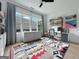 Bright and airy office space with large windows, colorful rug, and ample storage at 300 Mado Ln # 329, Chattahoochee Hills, GA 30268